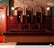 Oxblood tiles complement the underground feel
