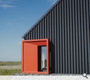 Bright red window 'hoods' frame landscape views