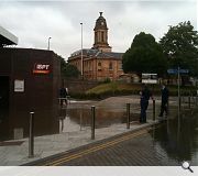 Workers stand helplessly as streams of water gurgle by