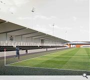 The larger east stand is centred on the reoriented pitch, sheltered by a profiled metal roof