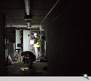 An engineer studies a diagram of the ageing electric wiring system in the basement