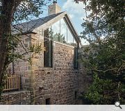 The rebuilt west gable brings the only exterior nod to the contemporary