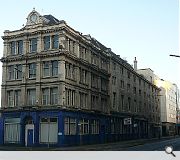 The former Co-operative funeral service building occupies a triangular island site on Morrison Street