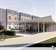 A powder coated metal cycle store features timber doors to individual bike lockers and a sedum roof