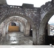 The fire-damaged loggia highlights the extent of restoration needed