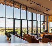 A dramatic glazed wall offers expansive views across the North Sea