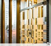 Smooth blue facing brick and oak screens contrast in quality with the bulk of the office block proper