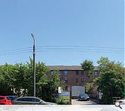 The disused yard mediates between tenements and garages