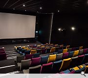 The main screen seats 150 and includes a small performance space in front of the auditorium for live events