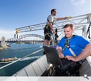 The Scottish Ten team perched atop one of the Opera House's iconic sails