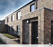 Entrance porches are picked out by textured brickwork