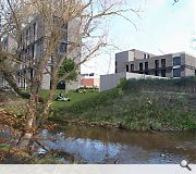 The site is bounded by the Water of Leith to the south