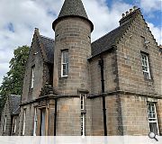 The mansion retains its distinctive crow-stepped gables, corbelled turrets and gables