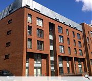 A palette of brick and set back zinc upper floors are designed to blend into the neighbouring streetscape