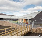 A classroom wing adopts the Highland vernacular of pitched ridges and gable ends