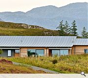 The timber and zinc clad home is low slung within the landscape