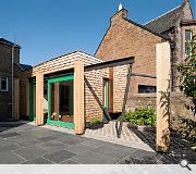 The green roof is supported by a zig-zag timber structure