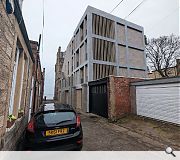 A four storey pre-cast concrete frame echoes the old water tower