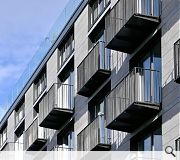 The building is clad in sandstone to the front with timber louvres providing privacy to the rear